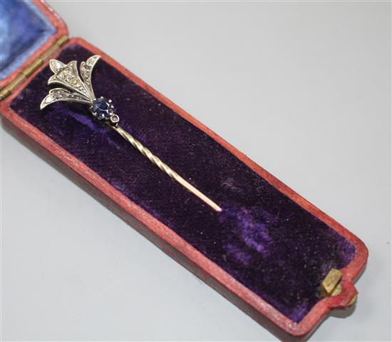 An early 20th century yellow and white metal, sapphire and diamond set stick pin, 62mm, gross weight 2.4 grams.
